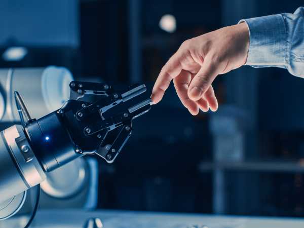 Menschliche Hand berhrt Roboterhand